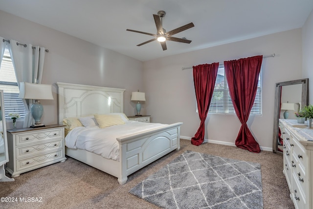 bedroom featuring multiple windows, ceiling fan, and carpet flooring