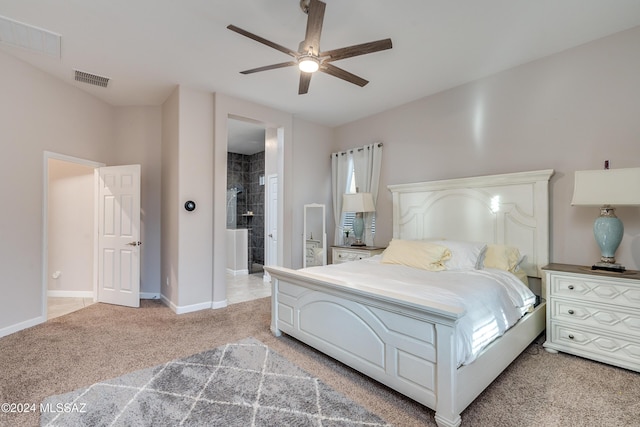 bedroom featuring ceiling fan, ensuite bathroom, and light carpet