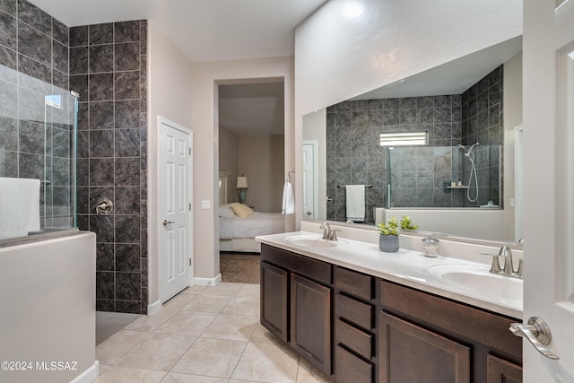 bathroom featuring vanity, tile patterned floors, and a tile shower