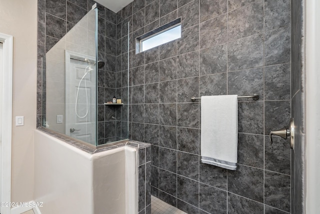 bathroom with a tile shower