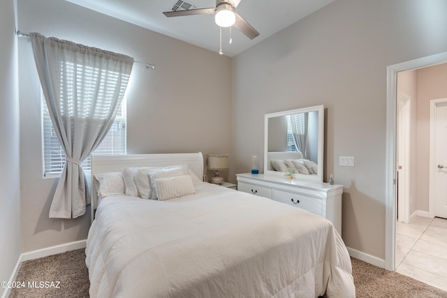 bedroom with vaulted ceiling, light carpet, and ceiling fan