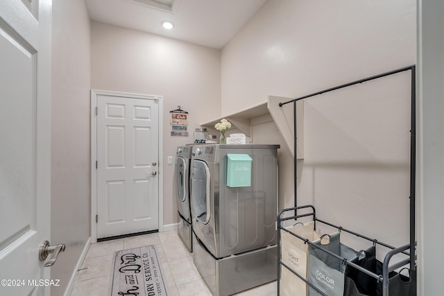 clothes washing area with light tile patterned floors and independent washer and dryer