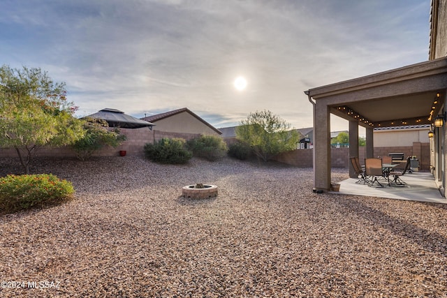 view of yard with a fire pit and a patio area