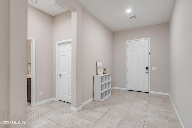 entryway with light tile patterned floors