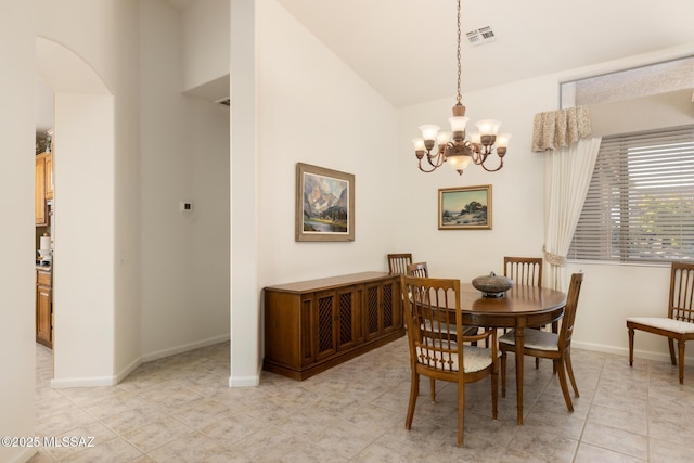 dining area with vaulted ceiling and a chandelier