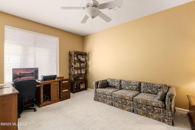 carpeted office space with ceiling fan, visible vents, and baseboards