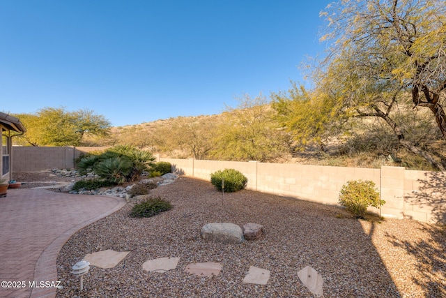 view of yard featuring a mountain view and a patio