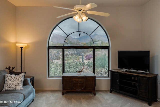 living room featuring light colored carpet and ceiling fan