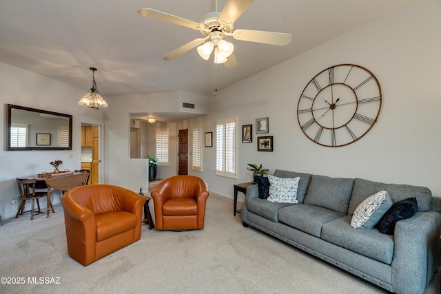 carpeted living room featuring ceiling fan