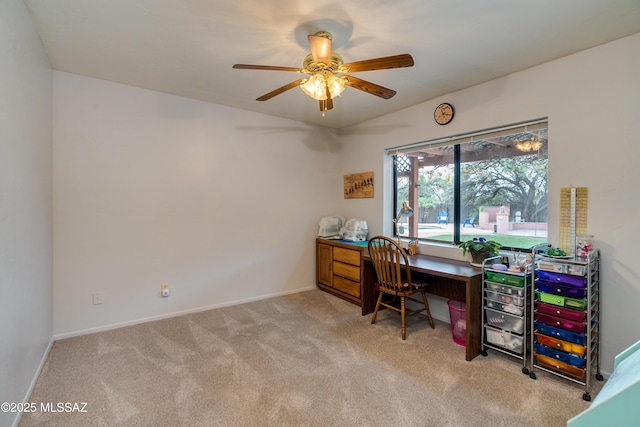 carpeted home office featuring ceiling fan