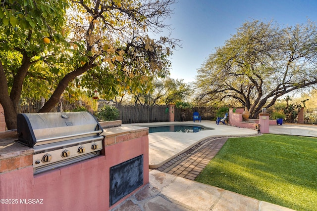 view of pool featuring area for grilling, a yard, grilling area, and a patio area