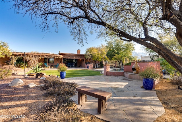 view of community with area for grilling and a patio