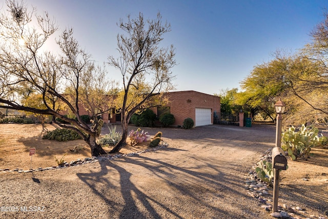 pueblo-style home with a garage