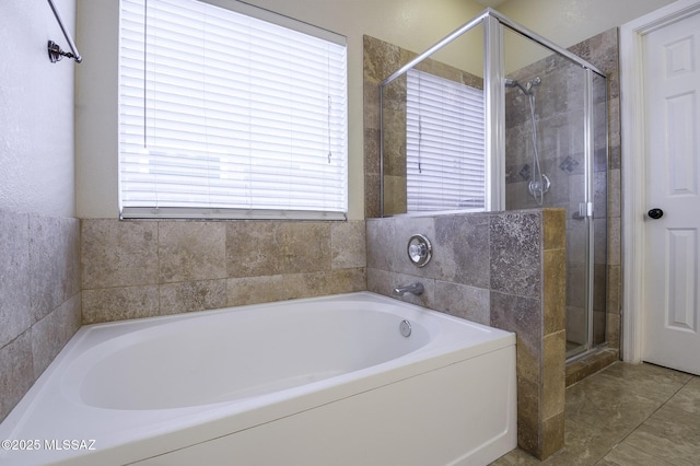 bathroom with shower with separate bathtub and tile patterned flooring