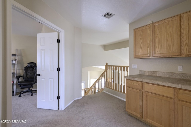 hallway with light colored carpet