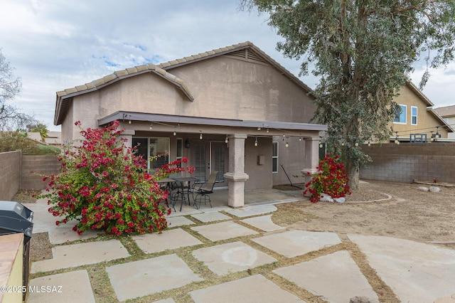 back of house with a patio