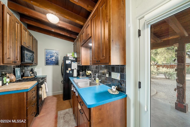 kitchen featuring tasteful backsplash, wood ceiling, sink, and black appliances