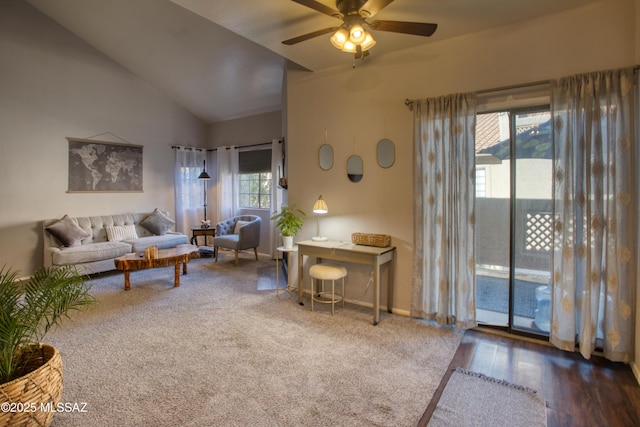 living area featuring lofted ceiling, wood finished floors, a ceiling fan, and baseboards