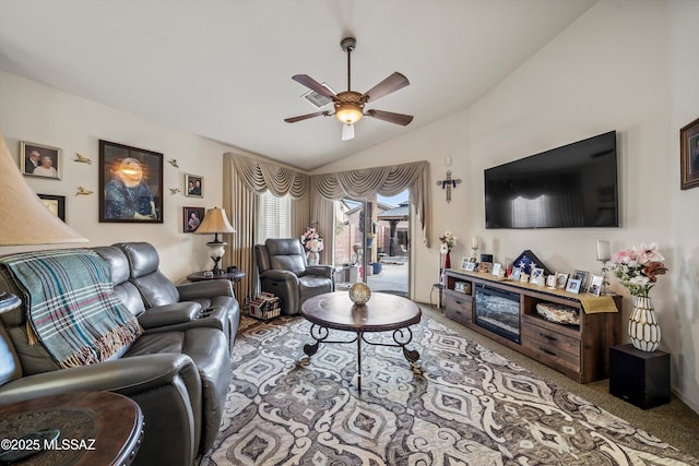 carpeted living room with vaulted ceiling and ceiling fan