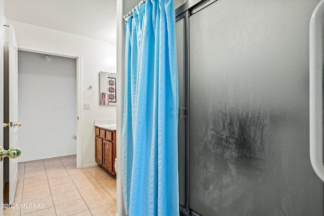 bathroom with vanity, a shower with shower door, and tile patterned floors