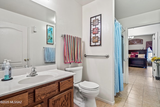 bathroom featuring tile patterned floors, vanity, and toilet