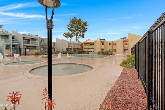 view of property's community featuring a hot tub