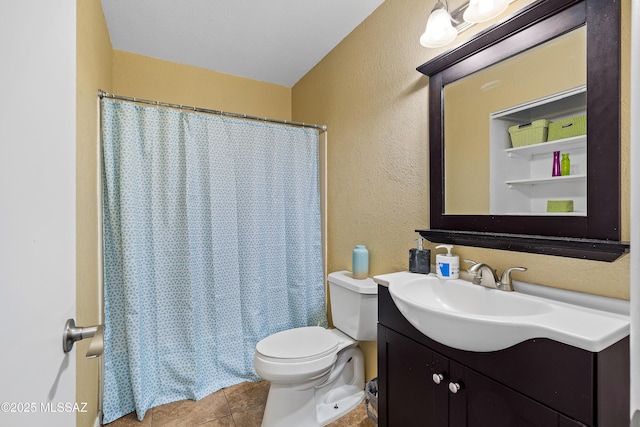 bathroom featuring a shower with curtain, vanity, tile patterned floors, and toilet