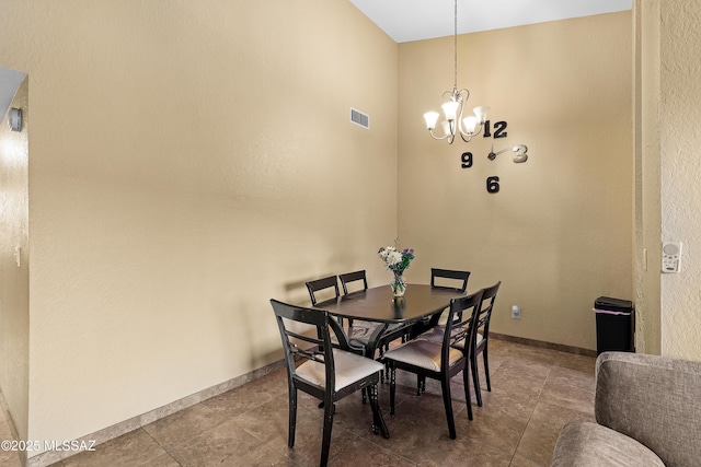 dining space with an inviting chandelier