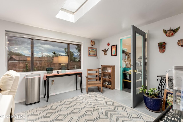 tiled office space featuring a skylight