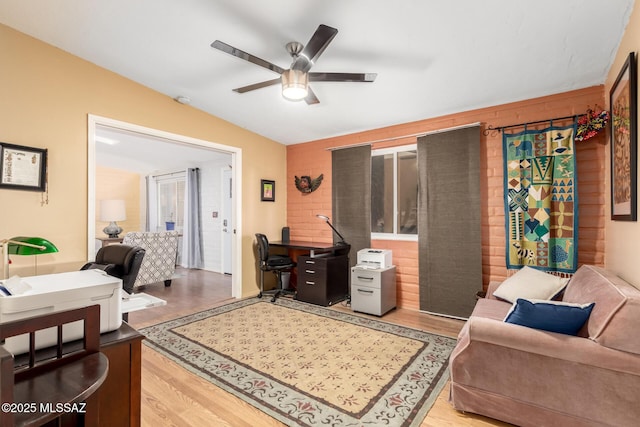 living room featuring ceiling fan and wood-type flooring