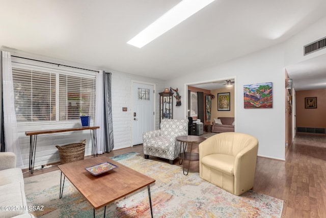 living room with wood-type flooring, ceiling fan, and vaulted ceiling