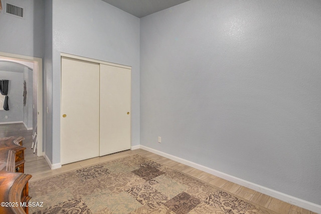 bedroom featuring light wood-type flooring and a closet