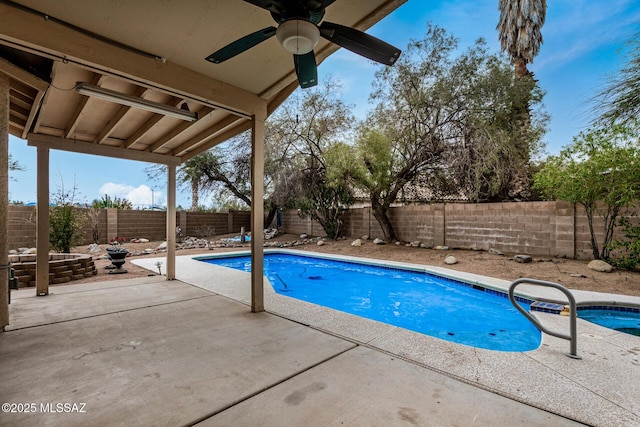 view of swimming pool featuring a patio and ceiling fan