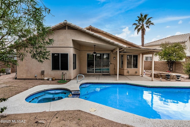 view of pool with an in ground hot tub, a patio, ceiling fan, and a fire pit