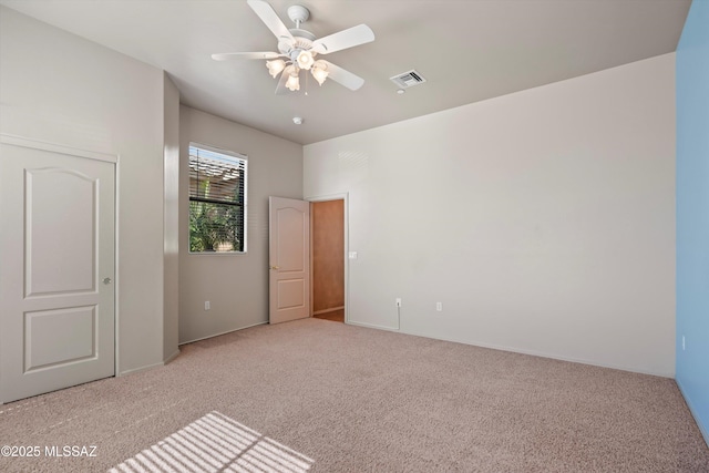 unfurnished bedroom featuring light colored carpet and ceiling fan