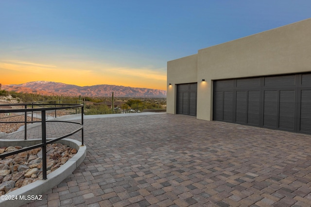 exterior space with a garage and a mountain view