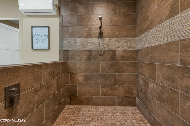 bathroom with a tile shower and a wall mounted AC