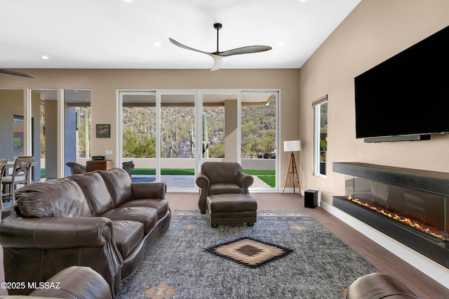 living room featuring hardwood / wood-style floors and ceiling fan