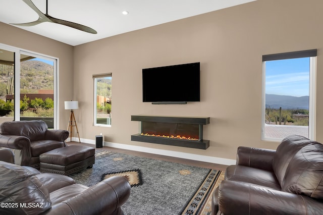 living room featuring wood-type flooring and ceiling fan