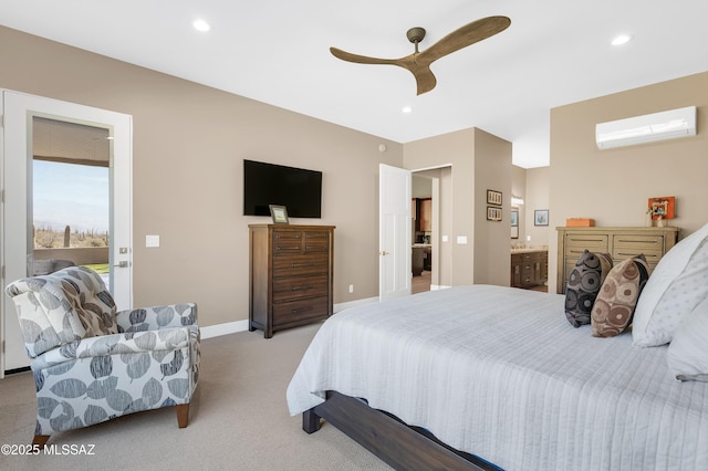 bedroom featuring light carpet, a wall mounted air conditioner, ceiling fan, and ensuite bathroom