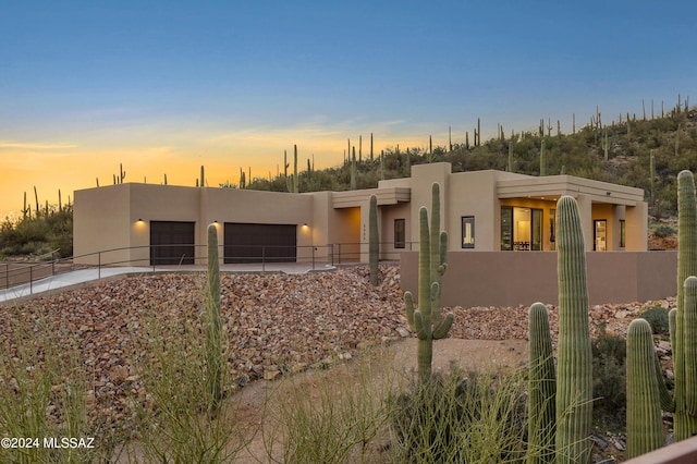 southwest-style home featuring a garage