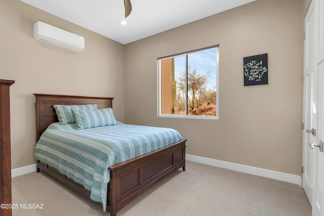 bedroom with light carpet and an AC wall unit