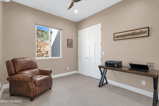 sitting room with ceiling fan and carpet flooring