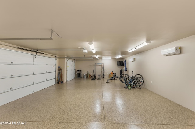 garage with a garage door opener and a wall mounted AC