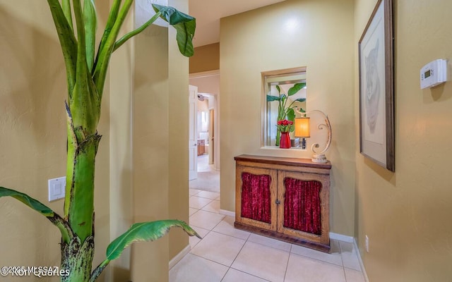 corridor with light tile patterned flooring