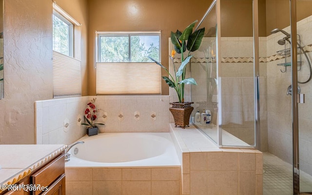 bathroom with vanity and independent shower and bath