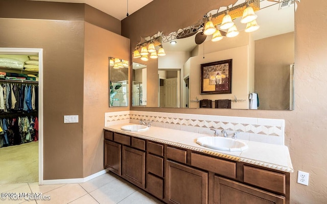 bathroom featuring vanity, backsplash, and tile patterned flooring