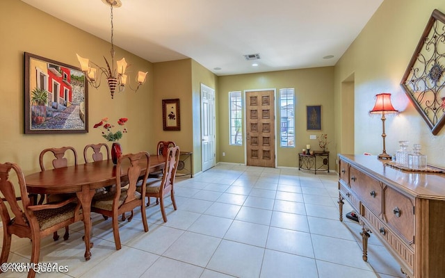 tiled dining space with an inviting chandelier