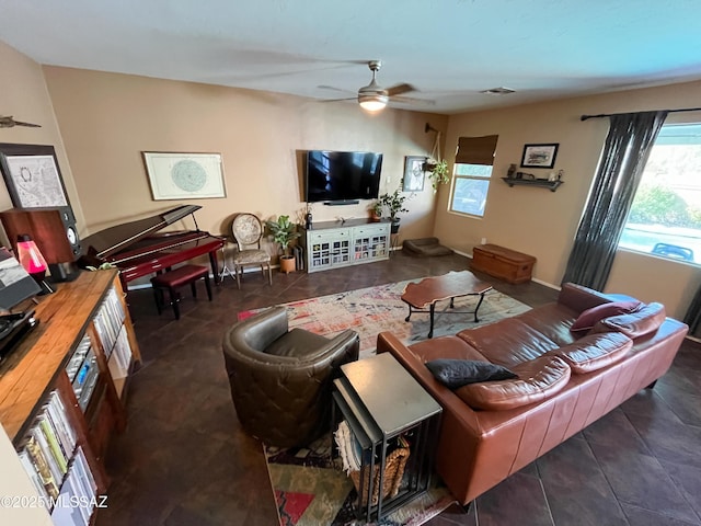 living room featuring dark tile patterned floors and ceiling fan