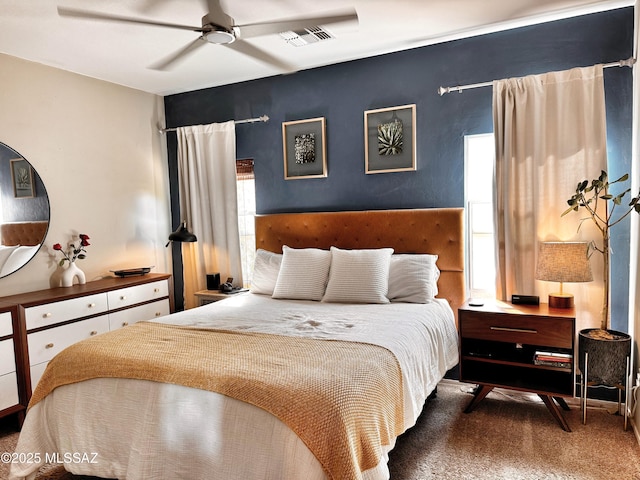 bedroom featuring dark colored carpet and ceiling fan